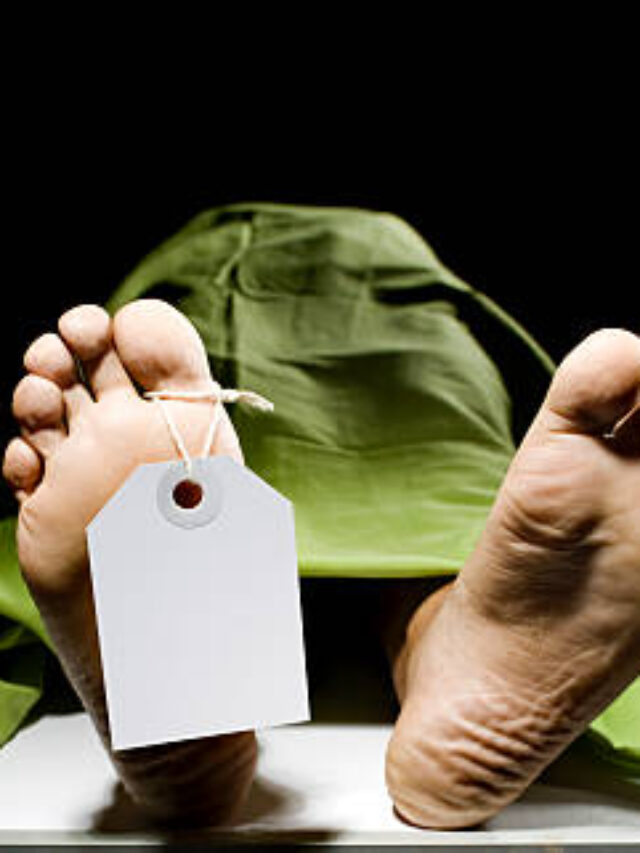 color image of feets of a corpse on a morgue wearing a toe tag